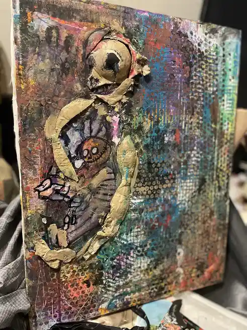 A textured, abstract painting depicts a large, beige skeleton holding a smaller, stitched baby skeleton. The background is a…