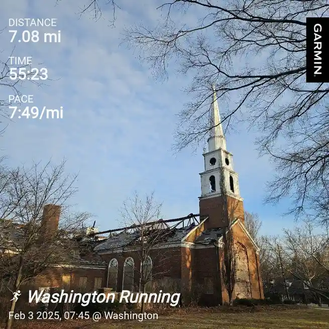 A screenshot from a Garmin fitness tracker shows a running workout log overlaid on a photo of a brick church with a damaged…