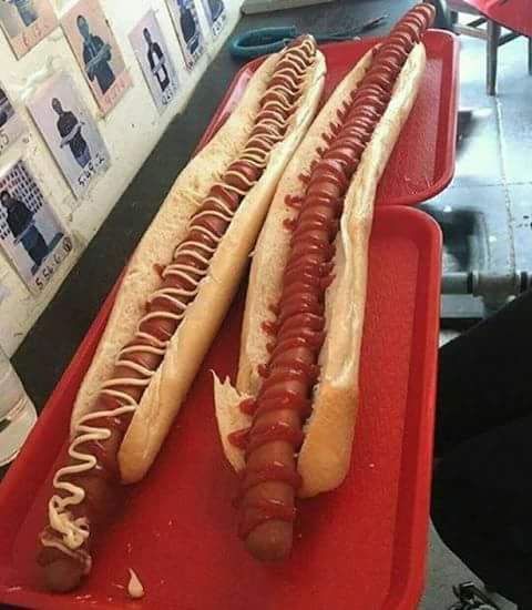 Two hot dogs on red trays, one with ketchup and mustard, the other with only ketchup. The text overlay reads 'hot dog with…