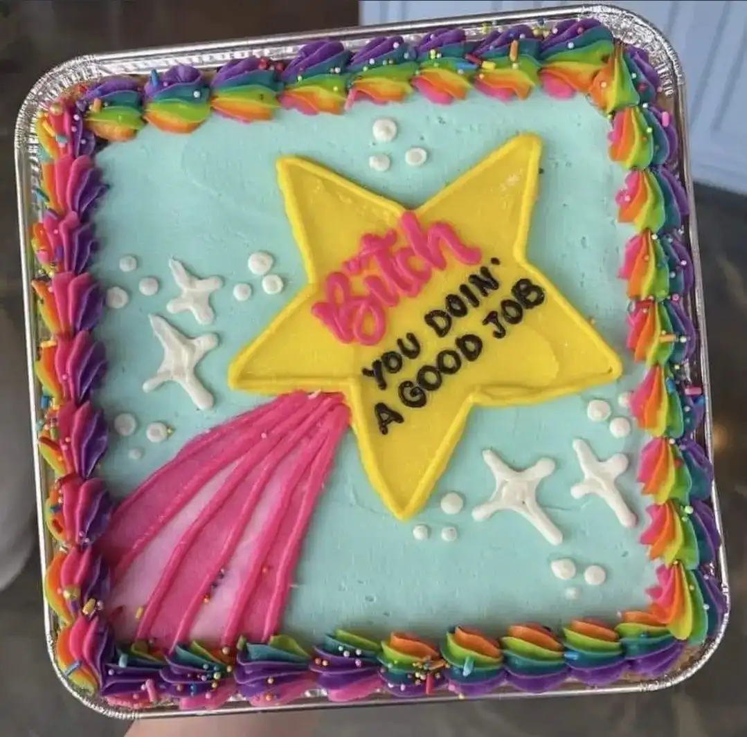 A square cake with light blue frosting, rainbow-colored piped borders, and white starfish decorations. A large yellow star…