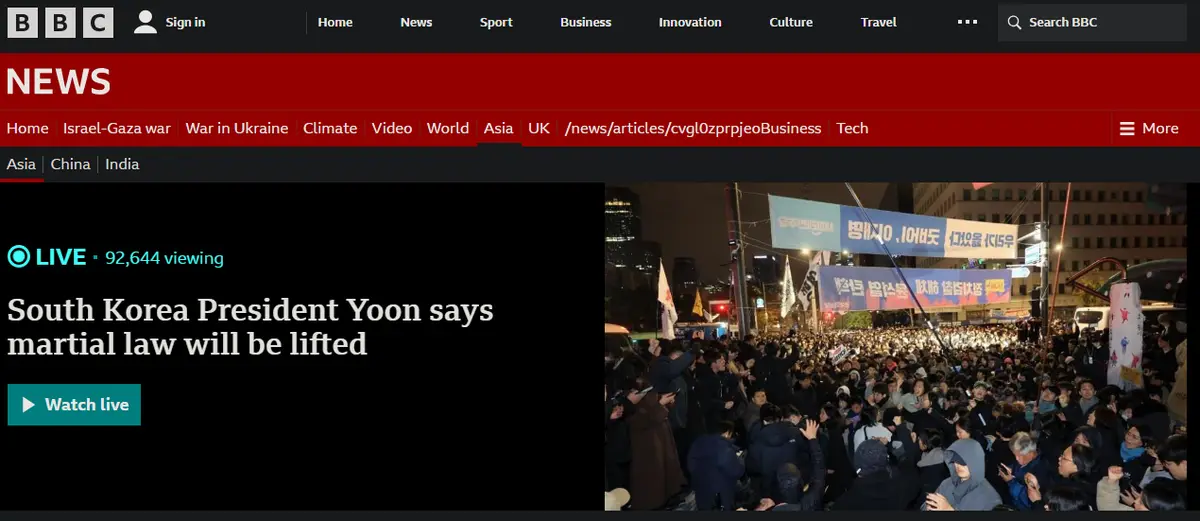A BBC News webpage screenshot shows a live article headline about South Korea President Yoon lifting martial law, juxtaposed…