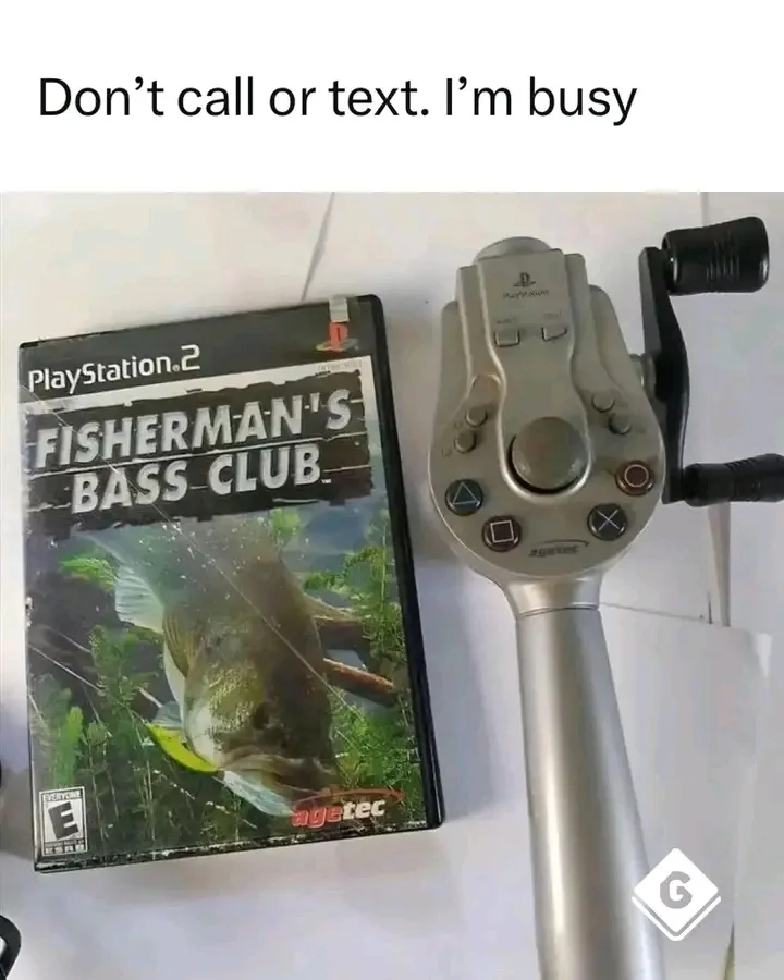 A PlayStation 2 game case for 'Fisherman's Bass Club' sits next to a physical fishing rod controller, which is a PlayStation…