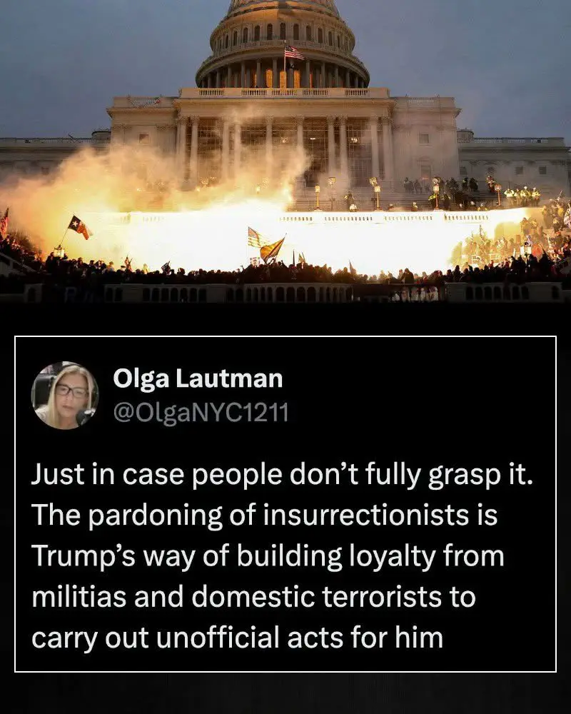 The image shows a large crowd gathered at the U.S. Capitol building during a protest, with smoke and flames visible at the…