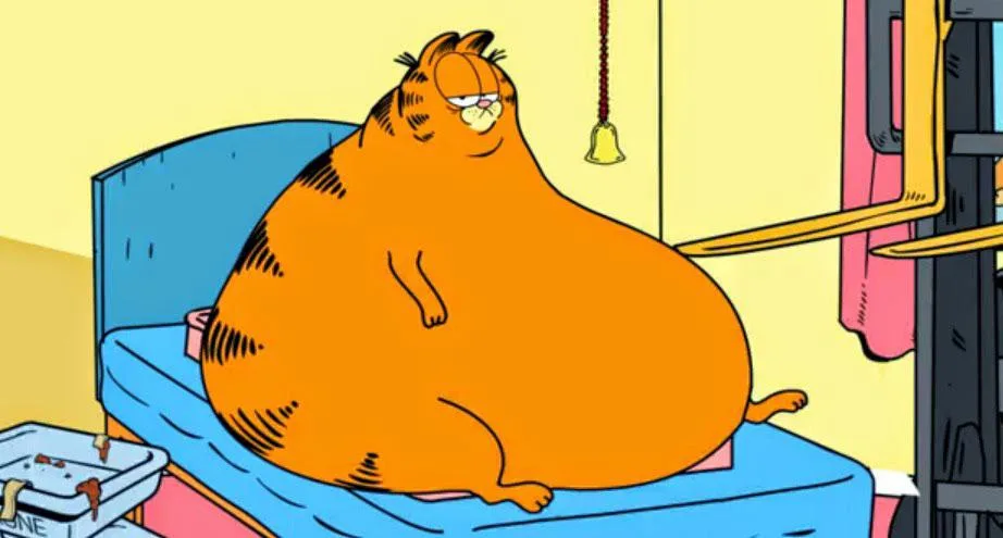 An extremely overweight orange cartoon cat, Garfield, sits lazily on a blue bed with a tired expression. A yellow bell hangs…